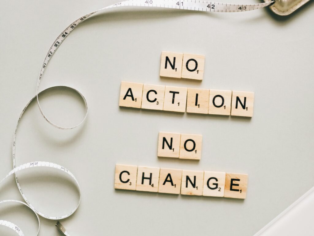 Letter tiles forming a motivational message alongside a scale and measuring tape.