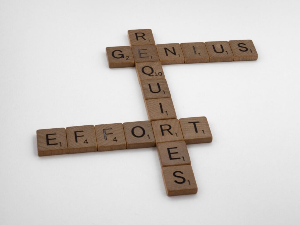 Wooden scrabble tiles arranged to spell inspiring words on a white background.